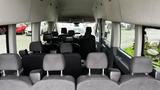 Interior view of a 2017 Ford Transit showing multiple rows of seats in a spacious layout with a cabin designed for passenger transport