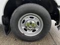 Close-up of a silver wheel on a 2011 Ford F-250 SD featuring a 6-lug design and a rugged tire tread