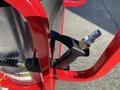 A red 2024 Magnum 4000 Hot Water Pressure Washer with a black trigger gun and brass fitting in the foreground