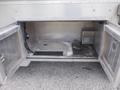 Open compartment of a 2007 Morgan Olson Workhorse W42 with metal doors revealing an empty space and wiring inside
