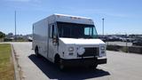 A white 2006 Ford Econoline box truck with a flat front and large windshield parked on a paved area