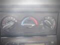 Climate control panel with dials for temperature and fan speed adjustment in a 2008 International 7400