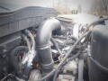 Engine compartment of a 2008 International 7400 with visible hoses and piping