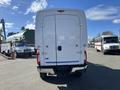 A white 2019 Ford F-350 SD cargo van with double rear doors and a sturdy build parked in a lot