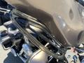 Close-up of a chrome handlebar and windshield attachment on a 2004 Harley-Davidson Flhtcui motorcycle