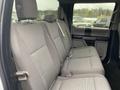 A 2017 Ford F-150 with a gray cloth interior featuring a spacious back seat layout with three seats and seatbelts