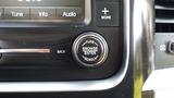 Close-up of a control knob on the dashboard of a 2014 RAM 5500 featuring buttons for tuning and browsing audio options