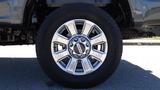 A close-up of a silver alloy wheel with a Michelin tire designed for a 2017 Ford F-350 Super Duty