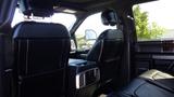 Interior view of a 2017 Ford F-350 SD showcasing black leather seats and a center console between the front seats