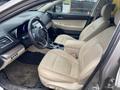 Interior of a 2019 Subaru Outback showcasing two beige leather front seats with a central console and dashboard visible