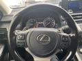 Close-up view of the steering wheel and dashboard of a 2021 Lexus NX 300 showing the Lexus emblem and instrument gauges