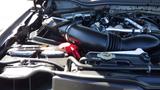 Close-up view of the engine compartment of a 2017 Ford F-350 SD featuring the air intake and various engine components