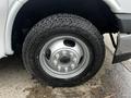 Close-up of a tire and wheel assembly of a 2017 Chevrolet Express showing a silver rim and rugged tread pattern