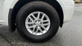 Close-up of the wheel of a 2016 Nissan Frontier showcasing the silver alloy rim and tire detail