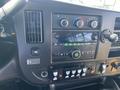 Dashboard of a 2017 Chevrolet Express with climate controls audio system and various buttons for vehicle functions