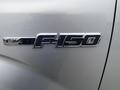 The image shows the chrome badge on the side of a 2014 Ford F-150 FX4 indicating the model and trim level