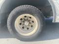 The close-up view of a tire from a 1999 Ford Econoline showing a five-spoke wheel with visible lug nuts and a tread pattern