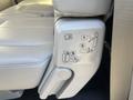 A close-up of the seat adjustment controls in a 2013 Ford Expedition showing icons indicating how to adjust the seat positions