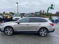 A 2019 Subaru Outback in silver color parked with a side view showcasing its sleek design and sporty wheels