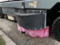 A close-up of a 2007 Tennant Sentinel floor scrubber showing the brush deck with some wear and discoloration on the pink protective skirt