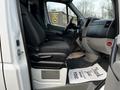 Interior view of a 2017 Mercedes-Benz Sprinter showing the driver's seat and dashboard with floor mats and a thank you note on the floor