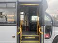 Interior view of a 2017 Chevrolet Express bus showcasing the entrance steps and driver’s seat visible inside