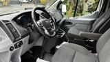 Interior of a 2017 Ford Transit van featuring a steering wheel dashboard and seating for two with fabric upholstery