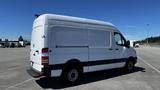 A white 2016 Mercedes-Benz Sprinter van viewed from the side showcasing its large cargo space and sleek design