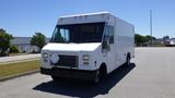 A white 2006 Ford Econoline delivery van with a boxy shape and large front windshield parked on a paved area