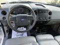 Interior view of a 2008 Ford F-150 XL featuring a steering wheel dashboard and control panel with climate controls and a radio display