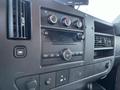 The interior dashboard of a 2009 GMC Savana featuring audio controls air conditioning vents and a digital display