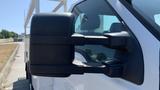 A side view of a 2011 Ford F-450 SD with a focus on the black side mirror and part of the vehicle's cabin