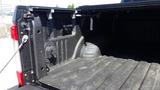 The image shows the bed of a 2017 Ford F-350 SD with a textured black liner and side panels featuring hooks and connectors for securing cargo