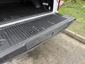 The tailgate of a 2018 Ford F-150 with a black bed liner showing grooves and textures designed for durability and cargo protection