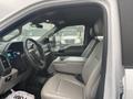 Interior of a 2021 Ford F-550 featuring gray leather seats a central console and modern dashboard with digital display