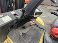 A close-up view of the control panel and foot pedals of a 2000 Hyster 120 forklift with visible wear and dirt on the surface