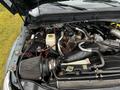 A close-up view of the engine compartment of a 2012 Ford F-550 featuring various engine components including a filter battery and hoses