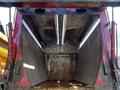 Interior of a 2009 Hino 338 garbage truck showing the empty loading compartment with metal walls and lighting fixtures above