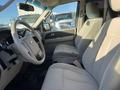 Interior of a 2013 Ford Expedition showcasing the front seats and steering wheel with light-colored upholstery and dashboard displays