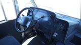 Interior view of a 2006 Ford Econoline dashboard with steering wheel gear shifter and various controls visible