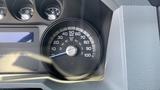 Speedometer of a 2011 Ford F-450 SD indicating a speed of 50 mph with fuel gauge and other dials visible in the background