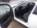 2008 Cadillac Limousine with a black leather interior featuring a steering wheel dashboard and control panel visible from the open driver's side door