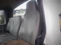 Two gray leather seats inside a 2006 International 4300 truck cabin, showing signs of wear and tear