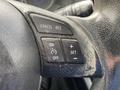 Close-up of the steering wheel controls in a 2016 Mazda CX-5 including buttons for cancel resume on off and set