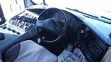 Interior view of a 2014 International 3000 bus showing the steering wheel dashboard controls and seat upholstery