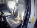 Interior view of a gray leather bench seat in a 2007 Ford F-650 with seatbelts and a fire extinguisher visible on the floor