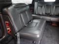 Interior view of a 2008 Cadillac Limousine showing a spacious black leather bench seat with seatbelts