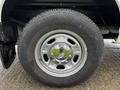 Close-up of a silver alloy wheel and tire from a 2011 Ford F-250 SD featuring five spokes and a central hubcap