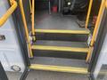 Steps leading into a 2017 Chevrolet Express with yellow handrails and non-slip treads