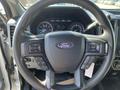 Steering wheel of a 2019 Ford F-350 SD featuring control buttons and the Ford logo in the center